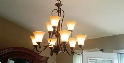 Classic ceiling chandelier installation with warm lighting in Savannah, GA