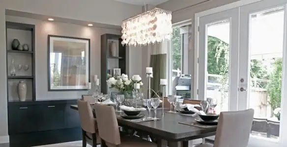 Elegant dining room chandelier installation above table in Savannah, GA