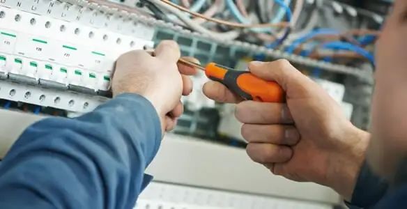 electrical service showing licensed electrician performing electrical panel maintenance and adjustments in Savannah, GA