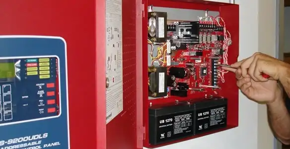 fire alarm installation service showing technician configuring fire alarm control panel in Savannah, GA