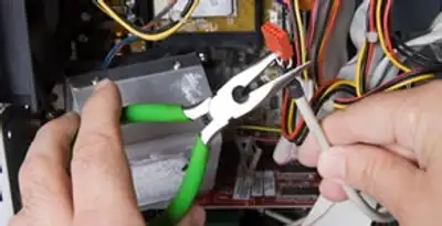 Licensed electrical contractor performing electrical repair with tools in Bloomingdale, GA