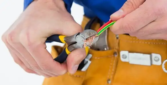 licensed electrician securing electrical wiring with professional tools during service work in Savannah, GA