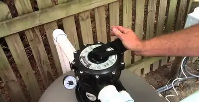pool pumps service showing professional adjustment of pool pump control system in Savannah, GA